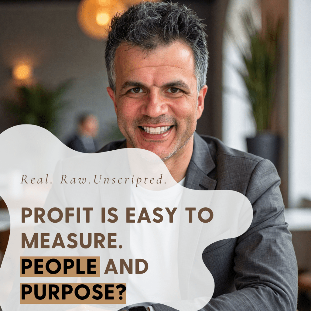 A smiling man in a suit, sitting at a table with a thoughtful expression, with text overlay discussing profit measurement and the importance of people and purpose.
