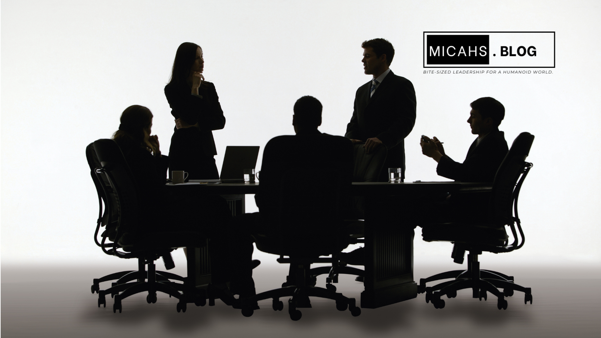 Corporate boardroom with executives nodding around a digital roadmap presentation, while below, floor employees appear disconnected and unaware—illustrating the leadership blind spot during tech rollouts.
